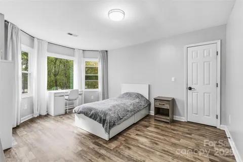 a bedroom with a bed and a large window