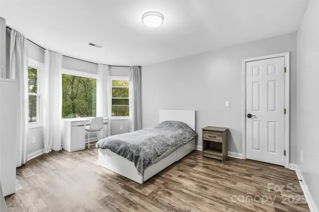 a bedroom with a bed and a large window