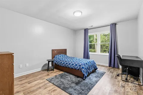 a bedroom with a bed a table and a window