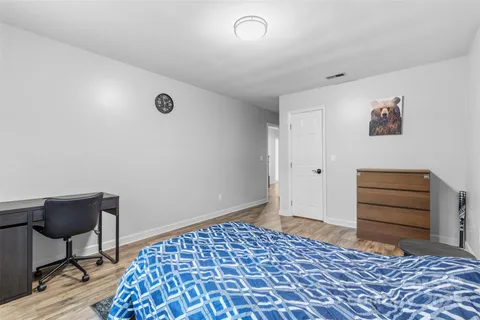 a bedroom with a bed and a chair