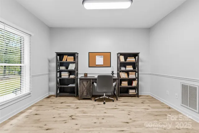 a view of a workspace with furniture and bathroom