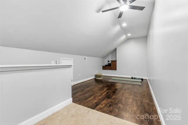 a view of a room with wooden floor and staircase