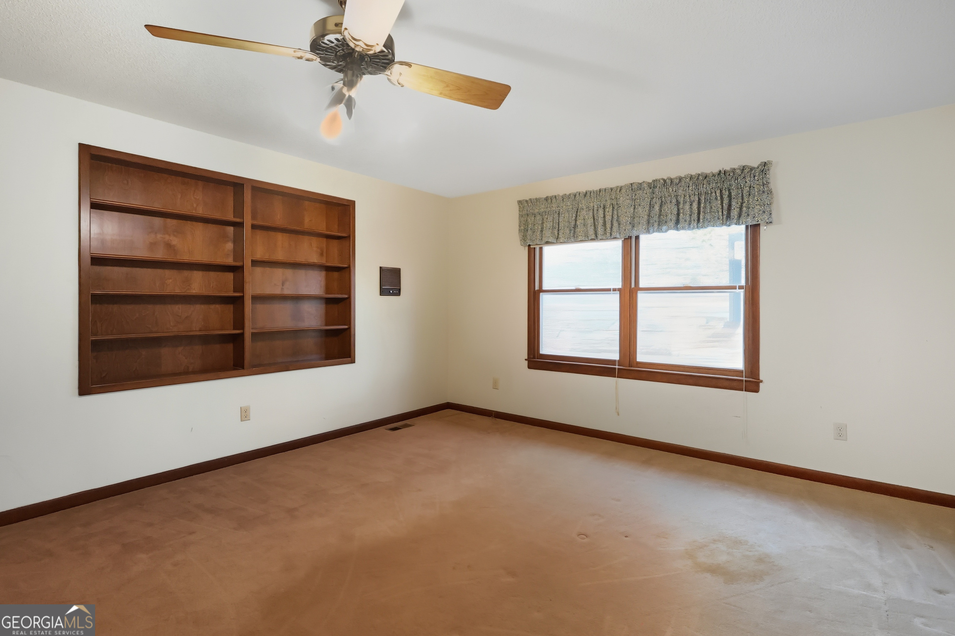 41 Brooks Street Royston, GA 30662 - Photo 19 of 44 an empty room with windows and fan