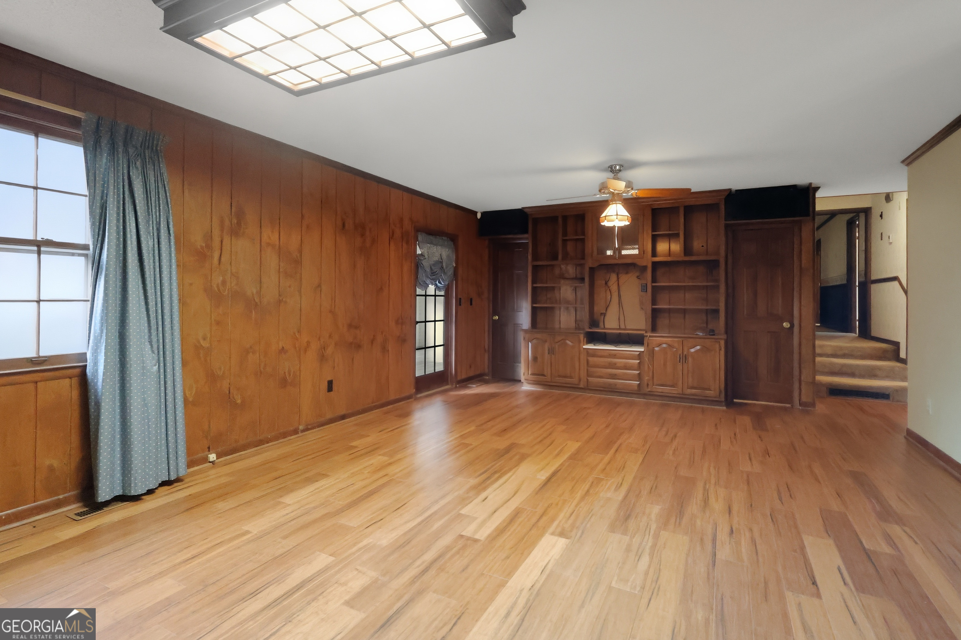 41 Brooks Street Royston, GA 30662 - Photo 8 of 44 an empty room with wooden floor closet and windows