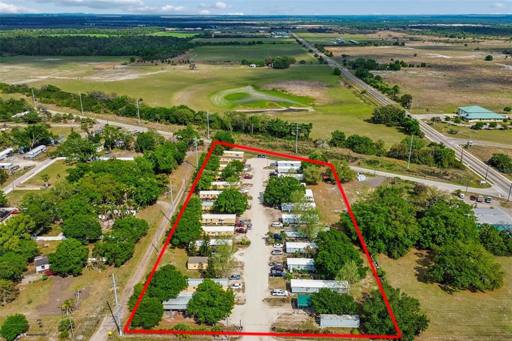 an aerial view of ocean with residential house and outdoor space
