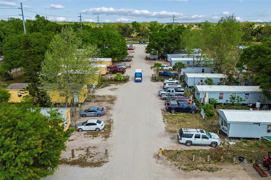 610 Railroad Street Wimauma, FL 33598 - Photo 13 of 34 an aerial view of a house with a yard lake and outdoor seating