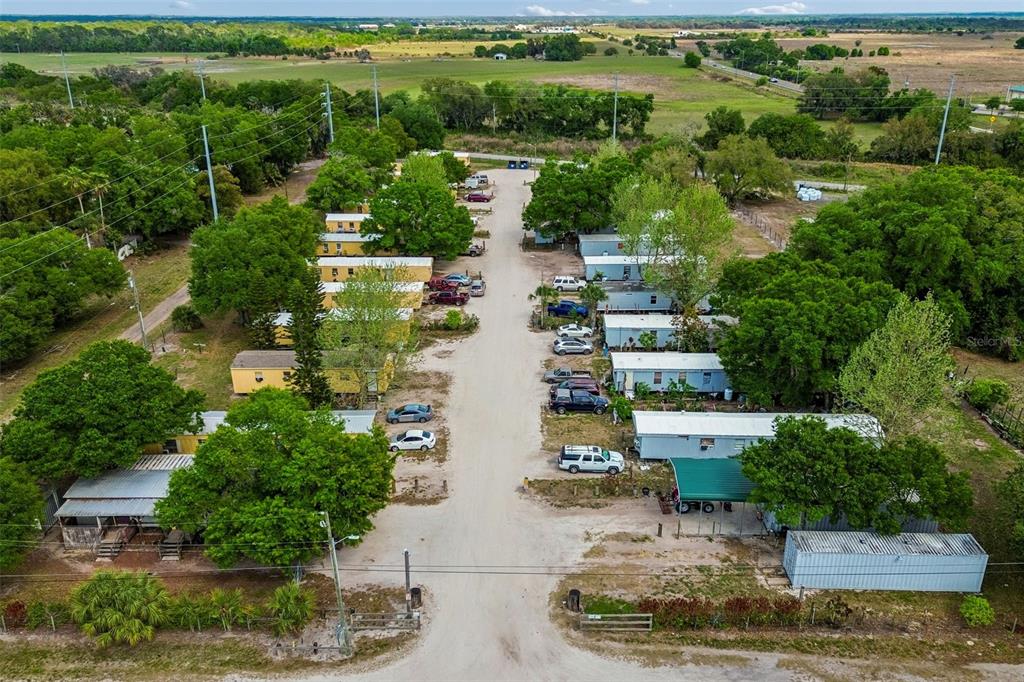 610 Railroad Street Wimauma, FL 33598 - Photo 15 of 34 an aerial view of a house with a yard and lake view