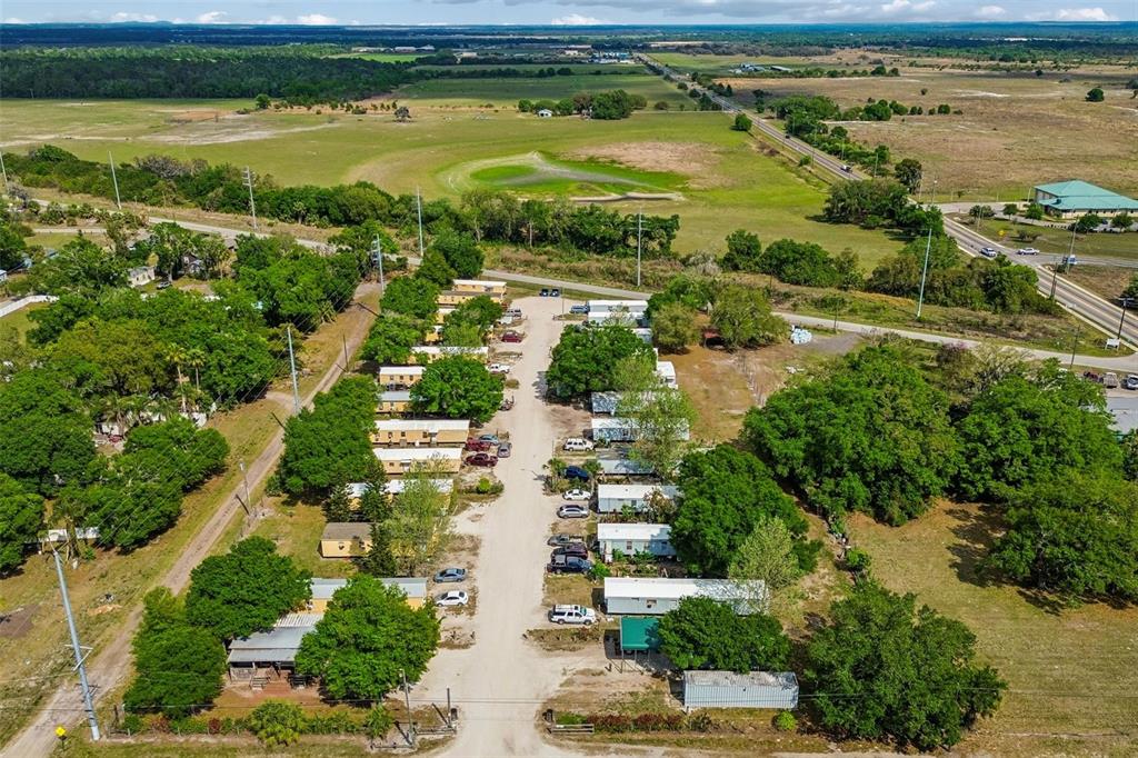 610 Railroad Street Wimauma, FL 33598 - Photo 21 of 34 an aerial view of residential houses with outdoor space and lake view
