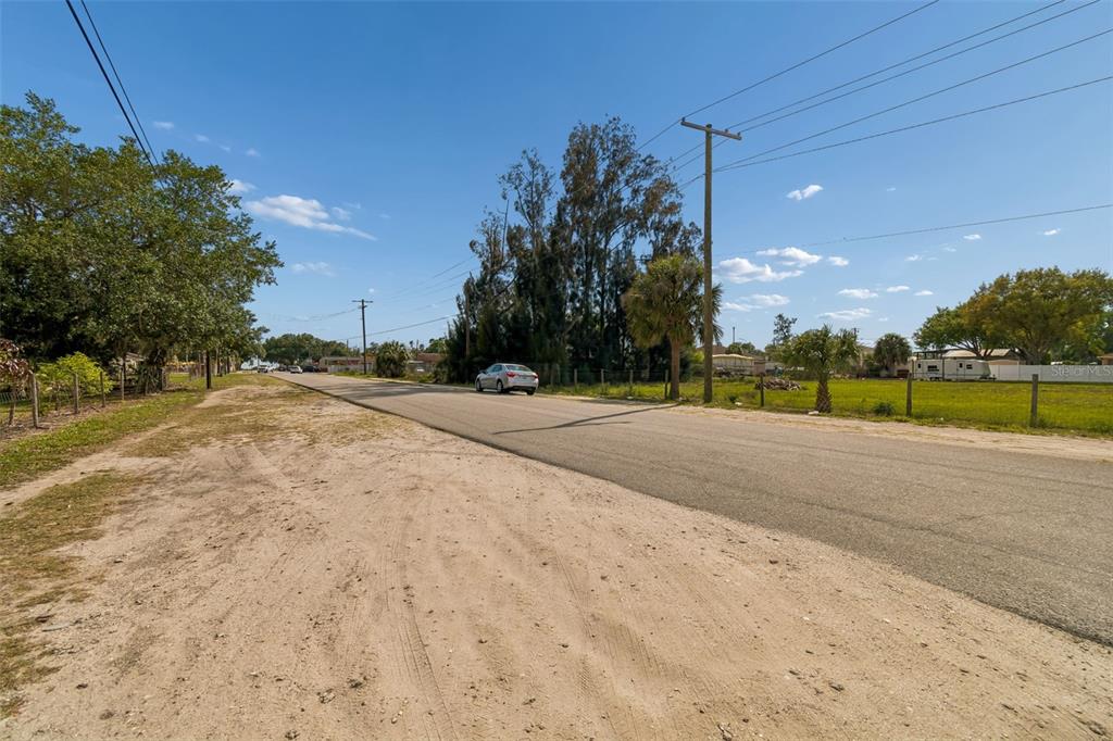 610 Railroad Street Wimauma, FL 33598 - Photo 34 of 34 a view of a road with a yard