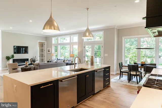 a kitchen with sink attached with living room