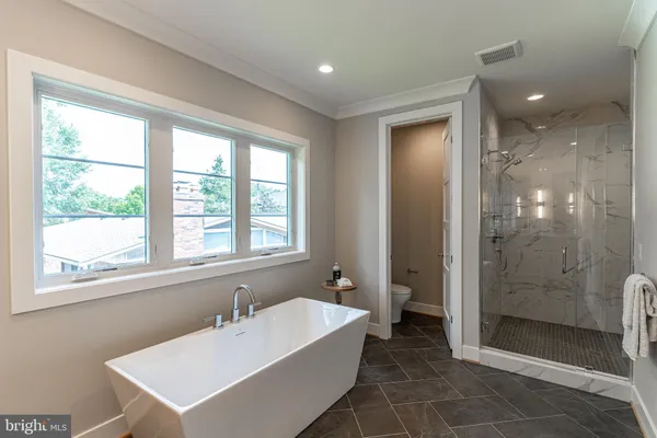 a bathroom with a bathtub a sink and a shower