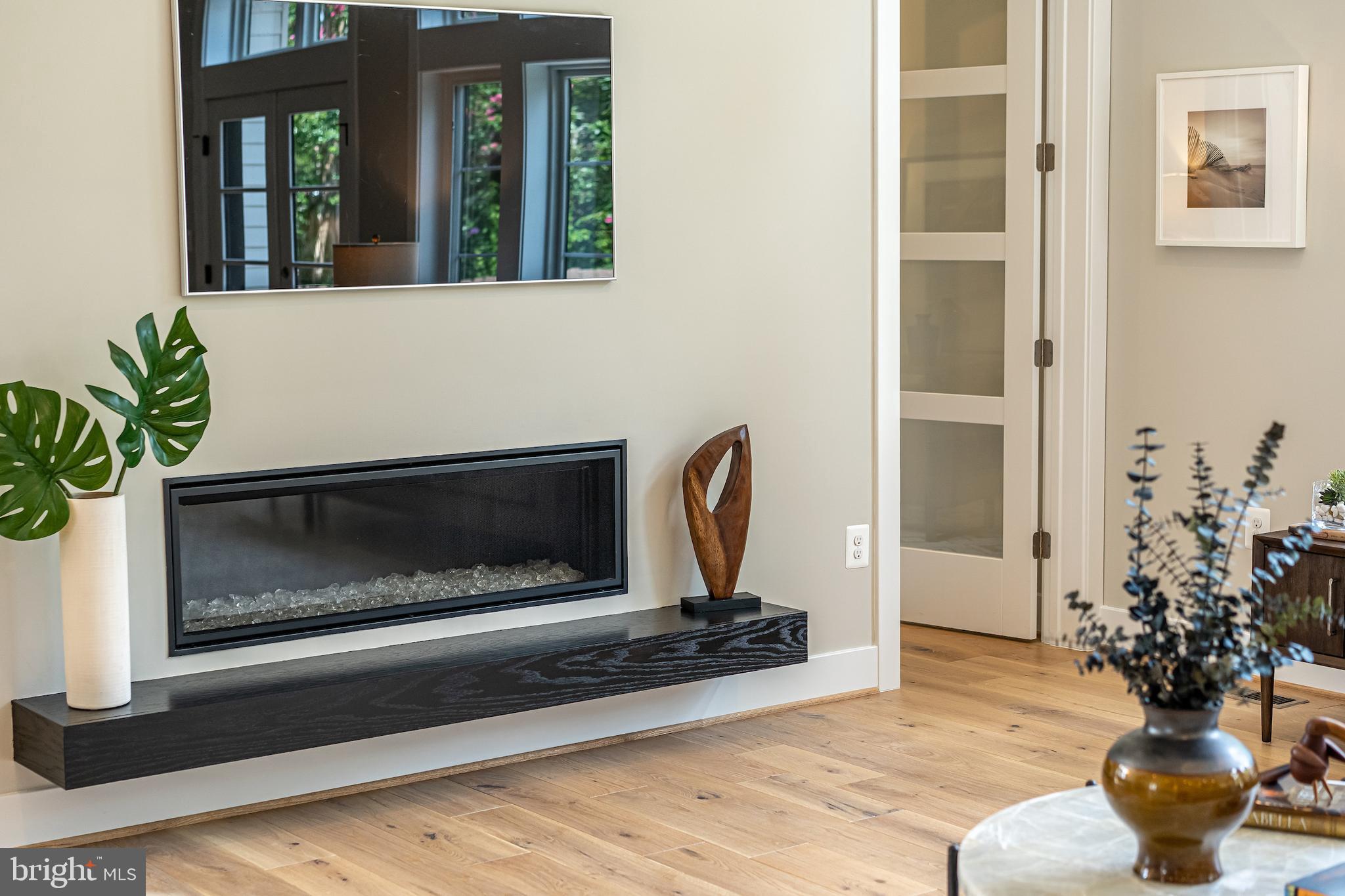 7205 Bayside Court McLean, VA 22101 - Photo 20 of 21 a living room with a fireplace and a potted plant