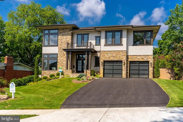 a front view of a house with a yard table and chairs