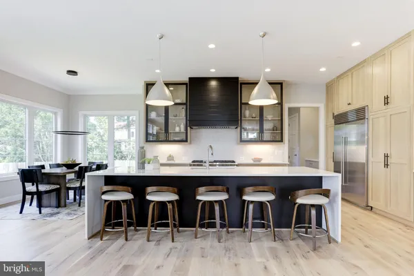 a large kitchen with a table and chairs