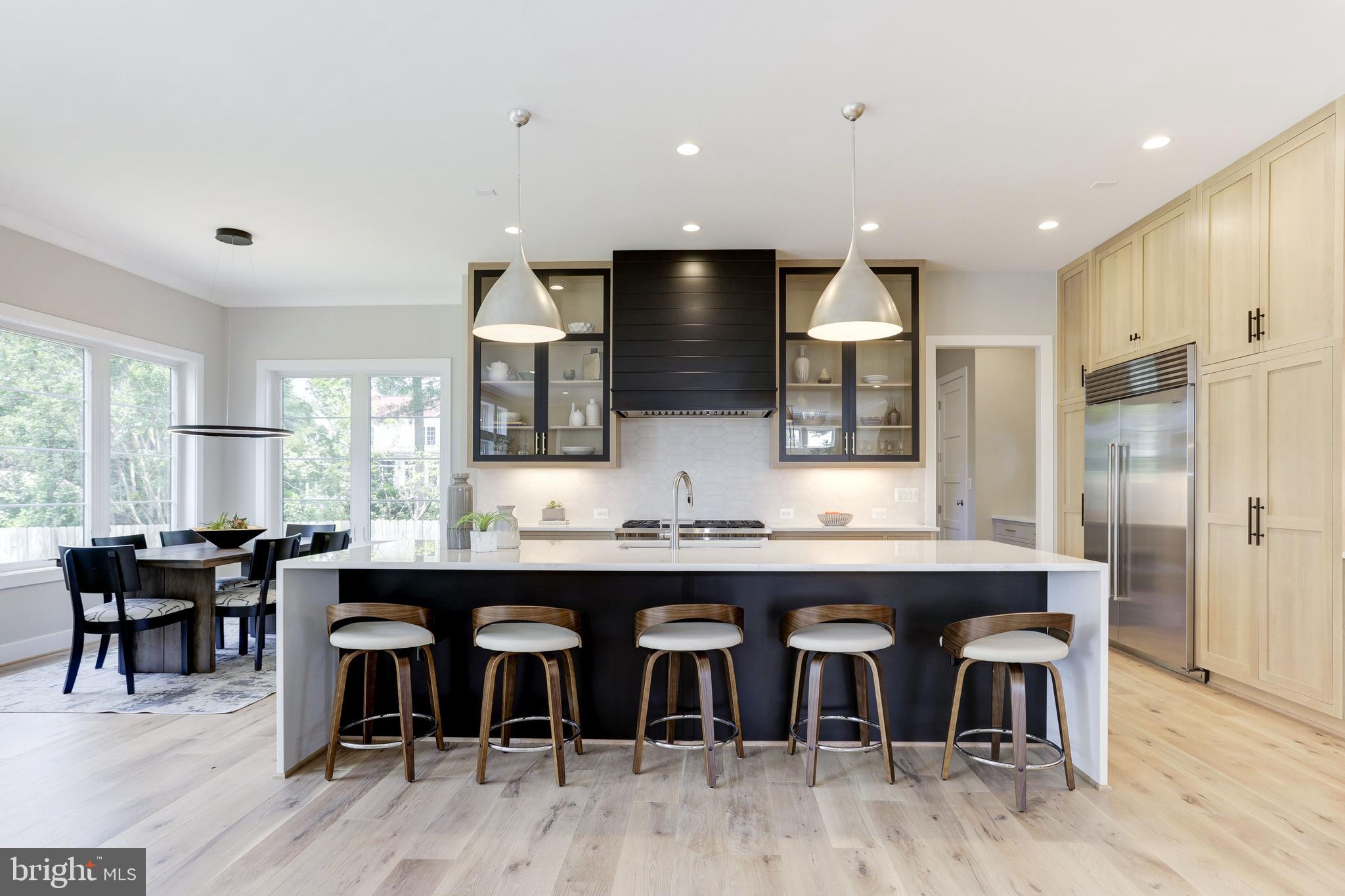 7205 Bayside Court McLean, VA 22101 - Photo 4 of 21 a large kitchen with a table and chairs