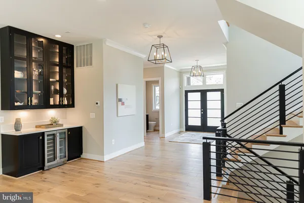 a view of a hallway with wooden floor and staircase