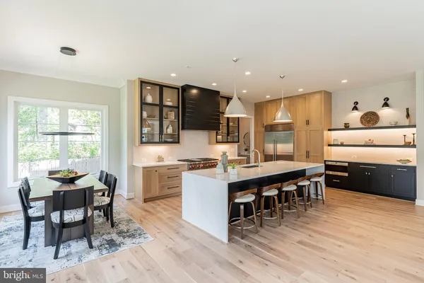 a kitchen with counter space dining table and stainless steel appliances