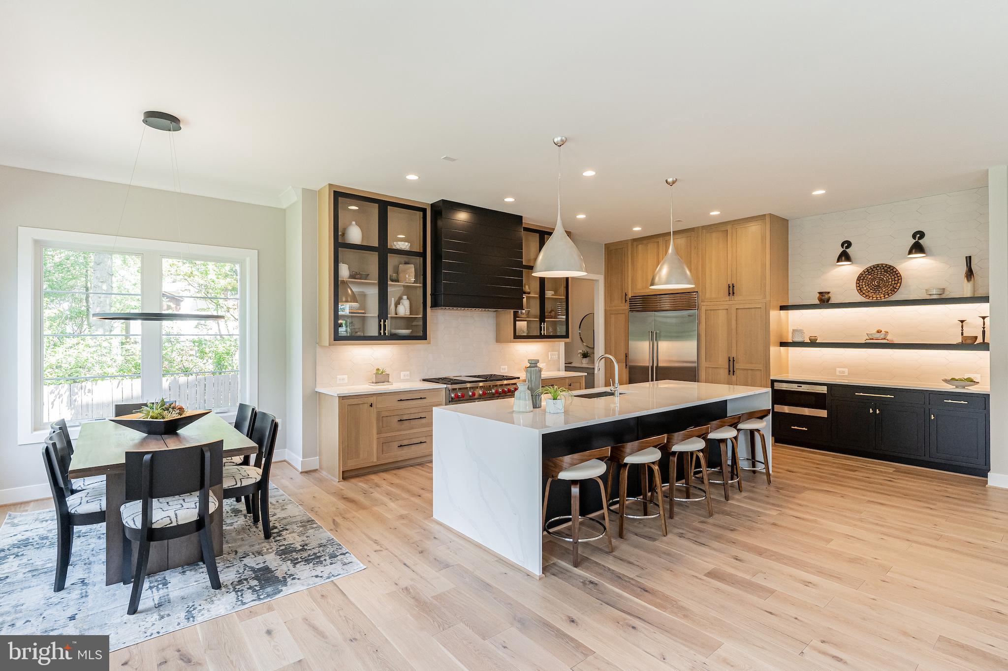 7205 Bayside Court McLean, VA 22101 - Photo 10 of 21 a kitchen with counter space dining table and stainless steel appliances