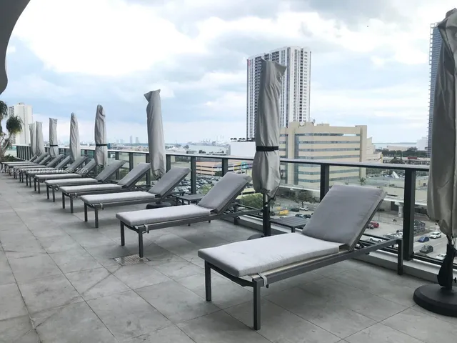 a roof deck with outdoor seating and city view