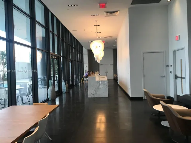 a view of a livingroom with furniture wooden floor and windows