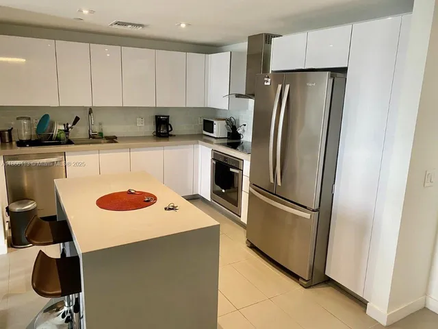 a kitchen with stainless steel appliances a refrigerator stove and sink