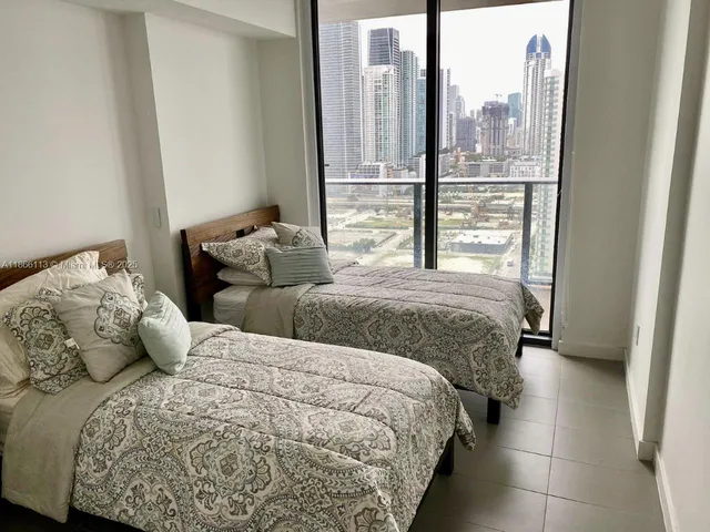 a bedroom with double bed and a window