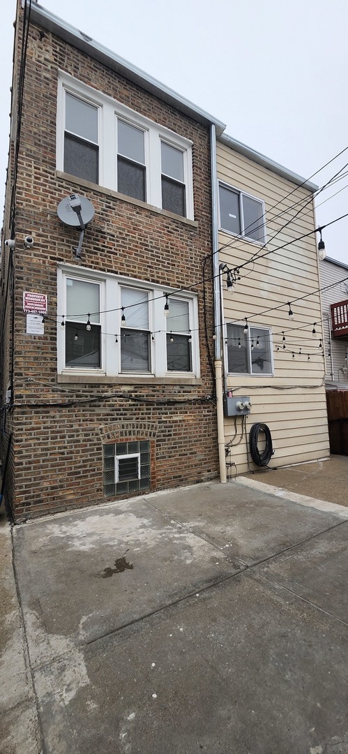4855 West Wolfram Street Chicago, IL 60641 - Photo 4 of 4 a view of a house with a yard