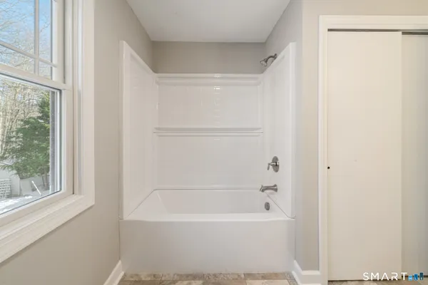 a bathroom with a toilet and a bathtub