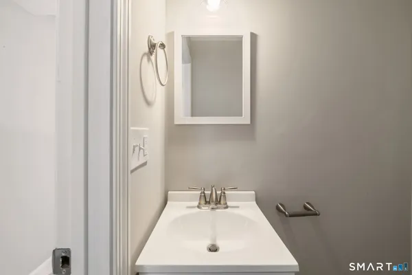 a bathroom with a sink mirror and toilet