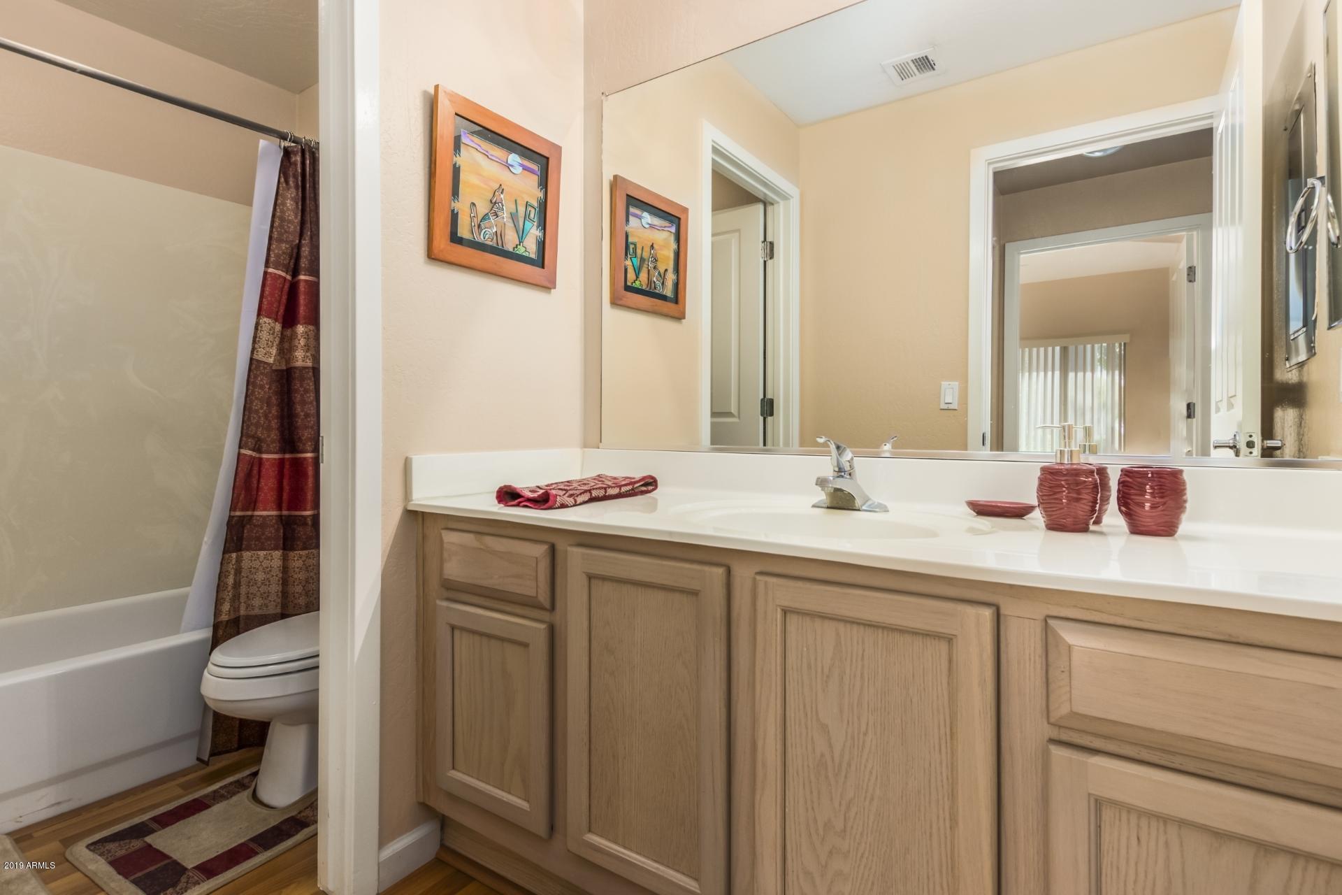 11260 North 92nd Street, Unit 1127 Scottsdale, AZ 85260 - Photo 17 of 42 a bathroom with a sink a toilet and a mirror