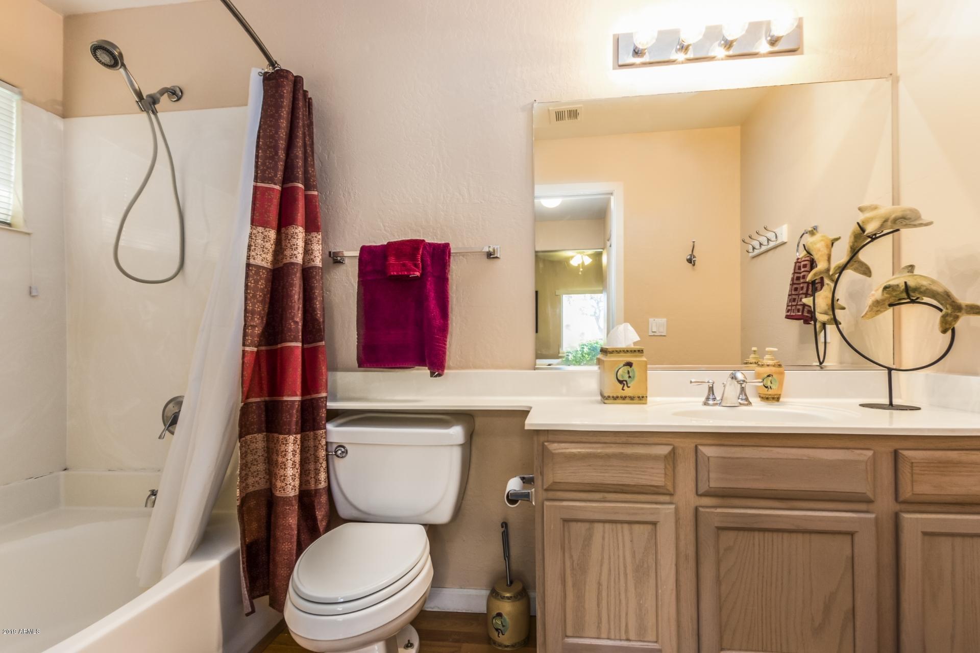 11260 North 92nd Street, Unit 1127 Scottsdale, AZ 85260 - Photo 20 of 42 a bathroom with a sink vanity mirror and toilet