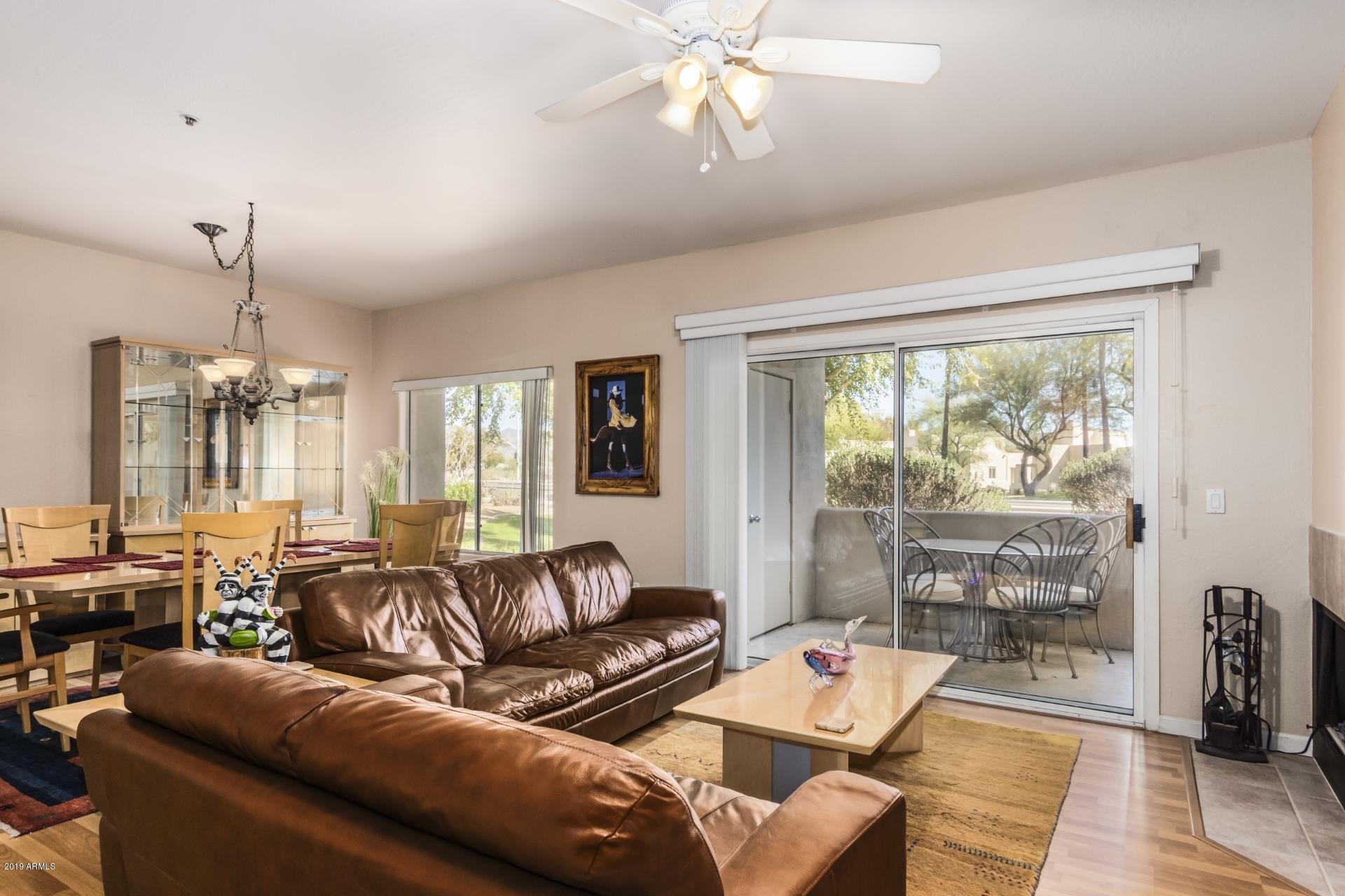 11260 North 92nd Street, Unit 1127 Scottsdale, AZ 85260 - Photo 24 of 42 a living room with furniture and a large window