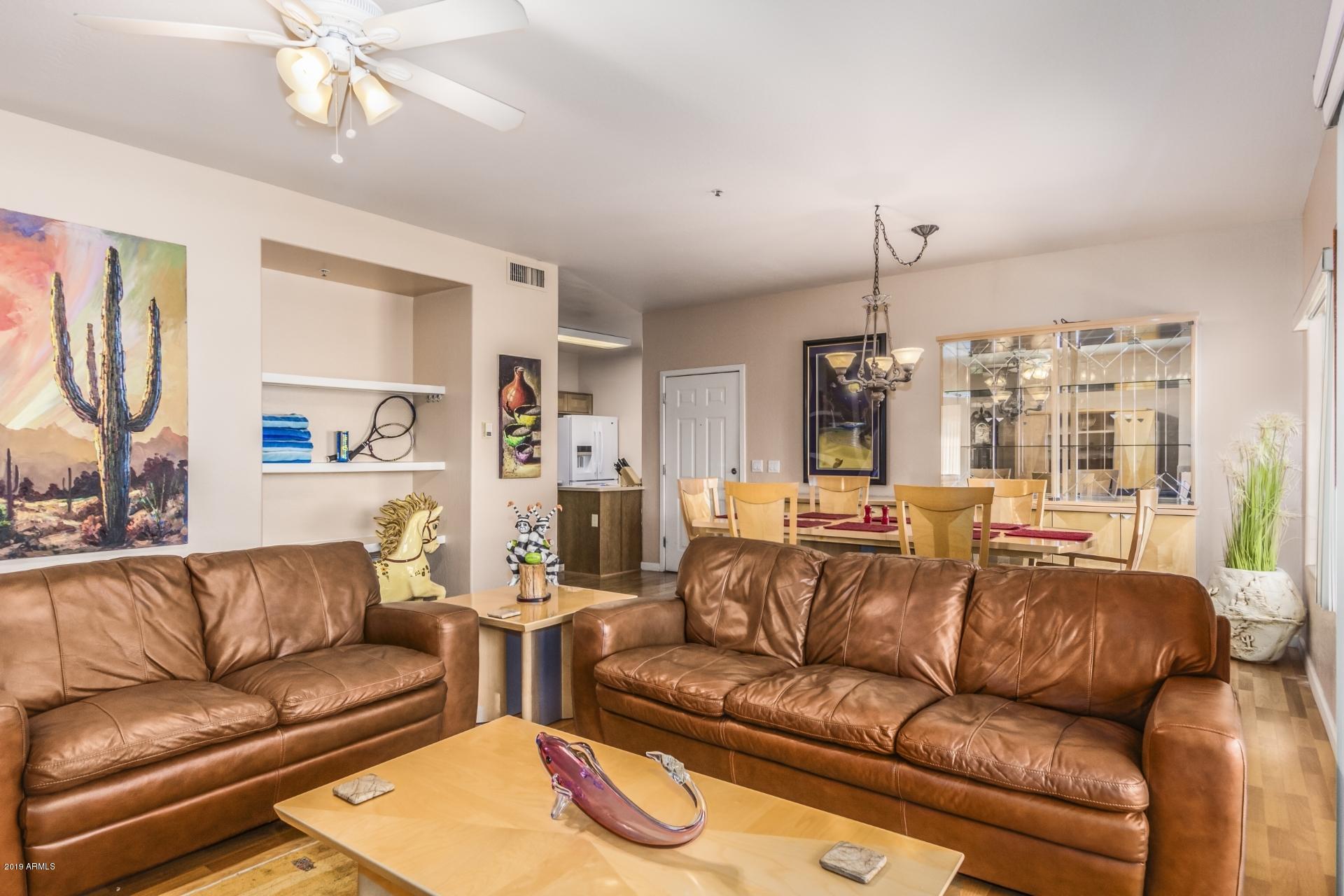 11260 North 92nd Street, Unit 1127 Scottsdale, AZ 85260 - Photo 27 of 42 a living room with furniture and a large window