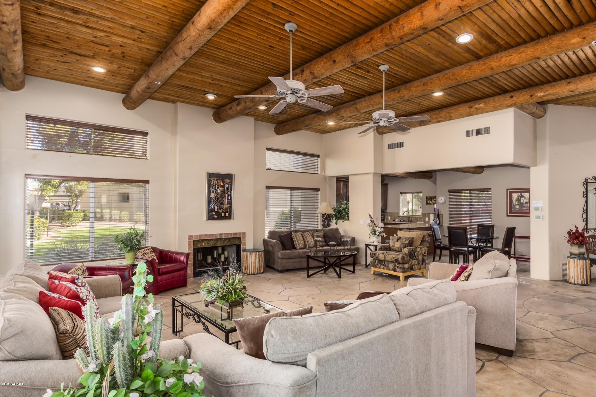 11260 North 92nd Street, Unit 1127 Scottsdale, AZ 85260 - Photo 31 of 42 a living room with furniture a chandelier