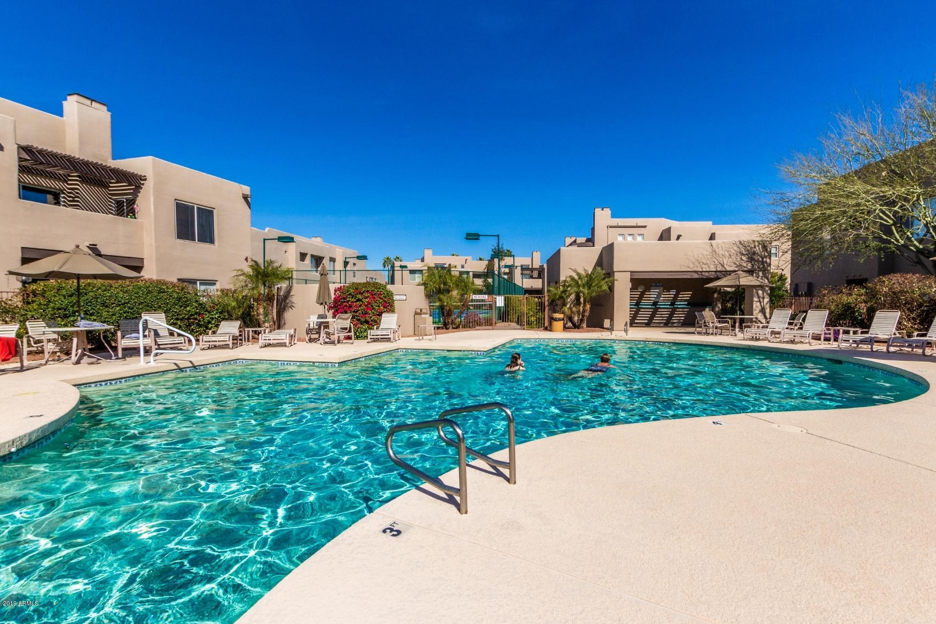11260 North 92nd Street, Unit 1127 Scottsdale, AZ 85260 - Photo 36 of 42 a view of a street with a building and trees in the background