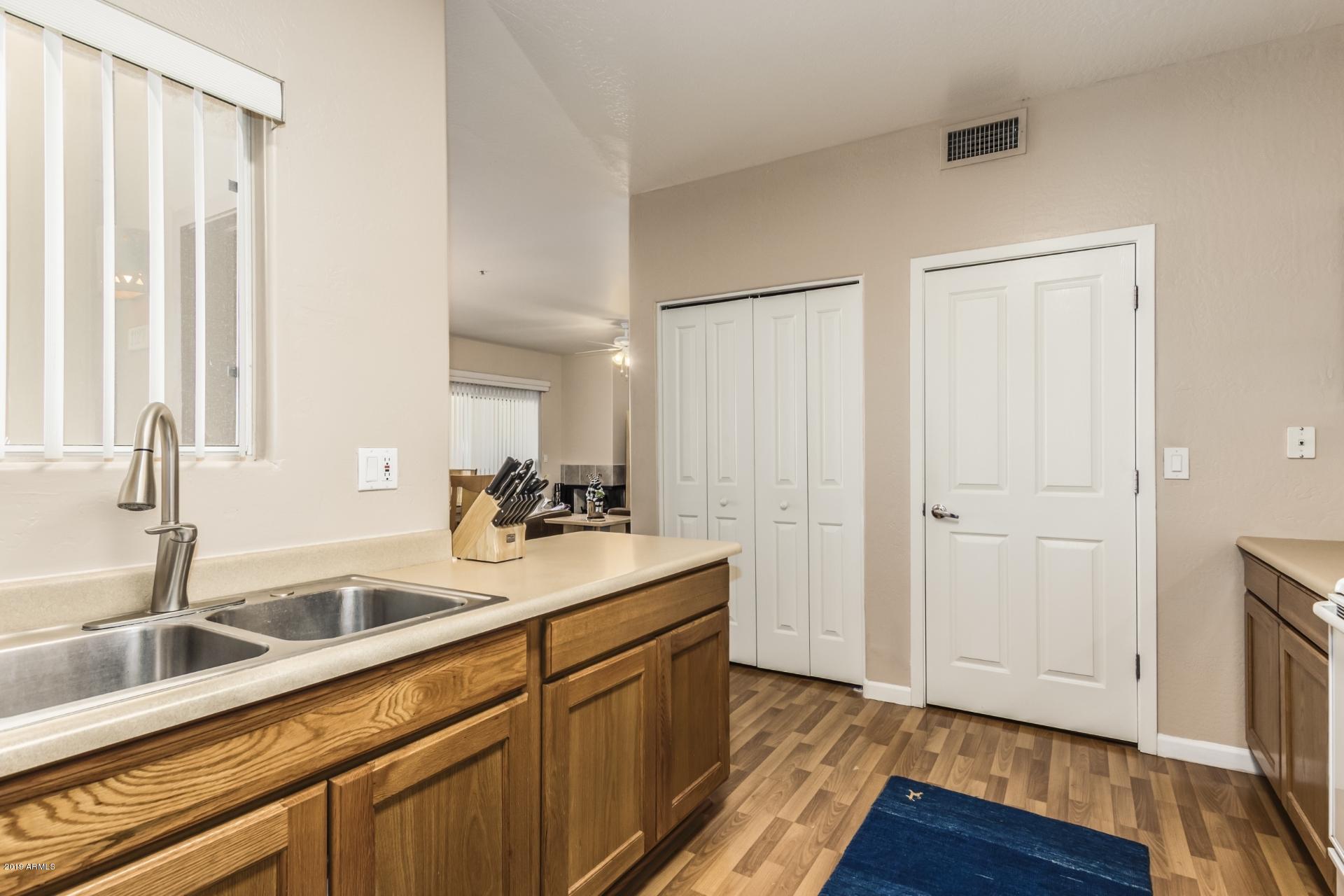 11260 North 92nd Street, Unit 1127 Scottsdale, AZ 85260 - Photo 7 of 42 a kitchen with a sink and a wooden floor