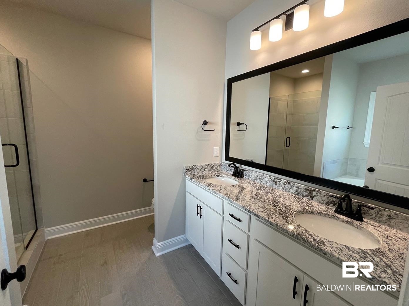 1634 Fenton Circle Foley, AL 36535 - Photo 6 of 14 Bathroom featuring double vanity, toilet, an enclosed shower, and hardwood / wood-style flooring