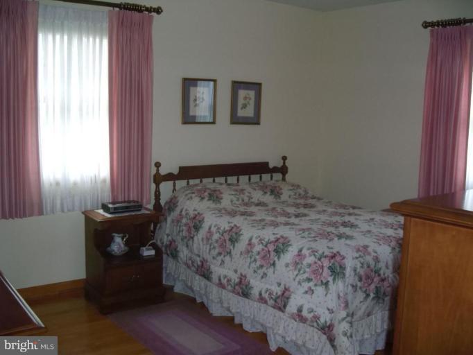 613 Shipley Road Linthicum Heights, MD 21090 - Photo 14 of 24 a bed sitting in a bedroom next to a window