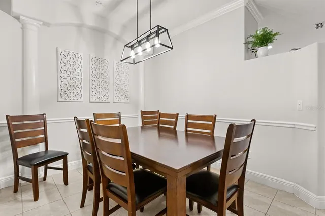 a view of a dining room with furniture and chandelier