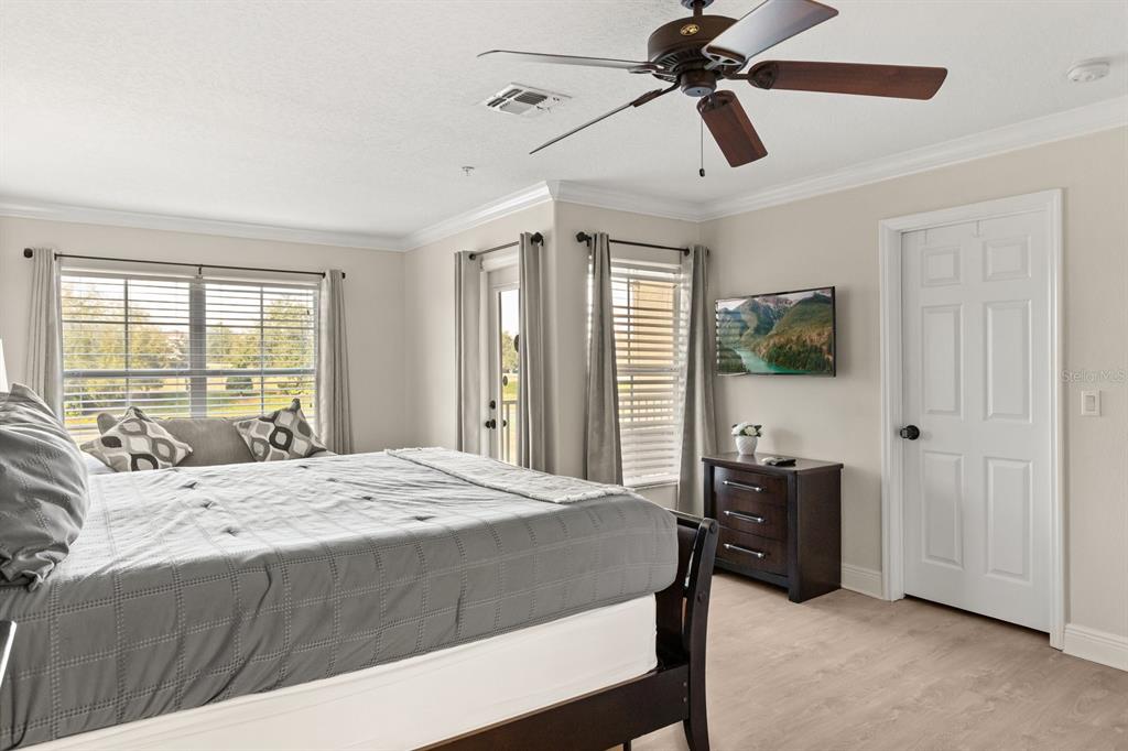 856 Assembly Court Reunion, FL 34747 - Photo 16 of 37 a bedroom with a bed a dresser and a chandelier