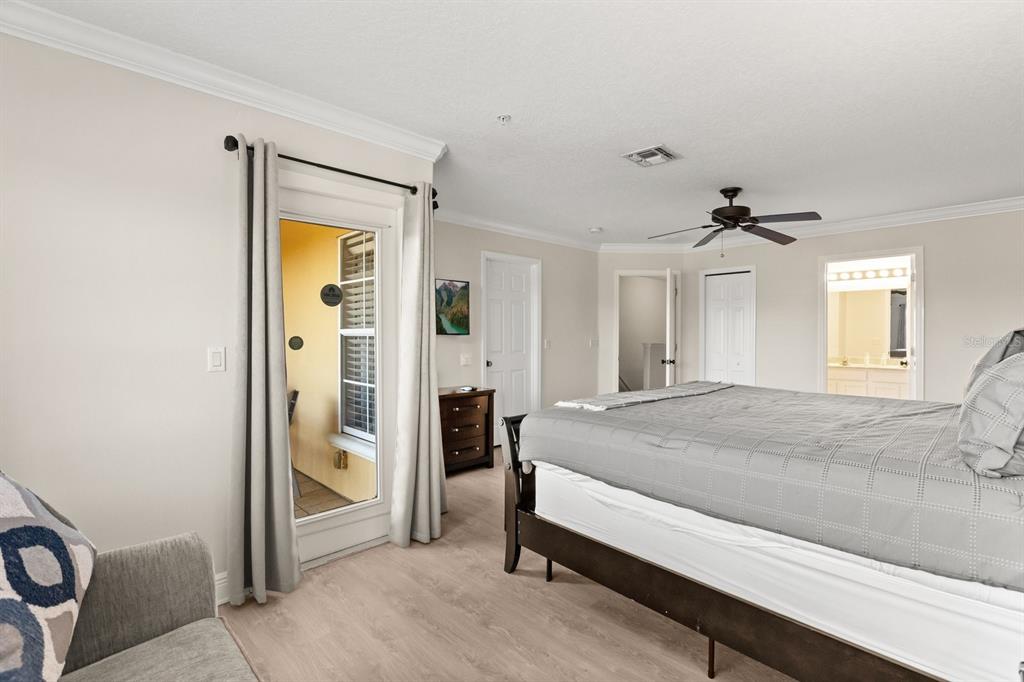 856 Assembly Court Reunion, FL 34747 - Photo 17 of 37 a spacious bedroom with a bed and a chandelier