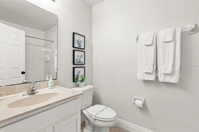 a bathroom with a tub a sink and mirror