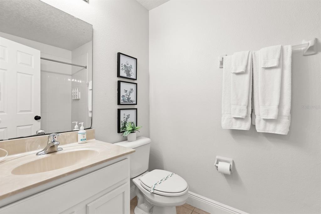 856 Assembly Court Reunion, FL 34747 - Photo 20 of 37 a bathroom with a toilet sink and mirror