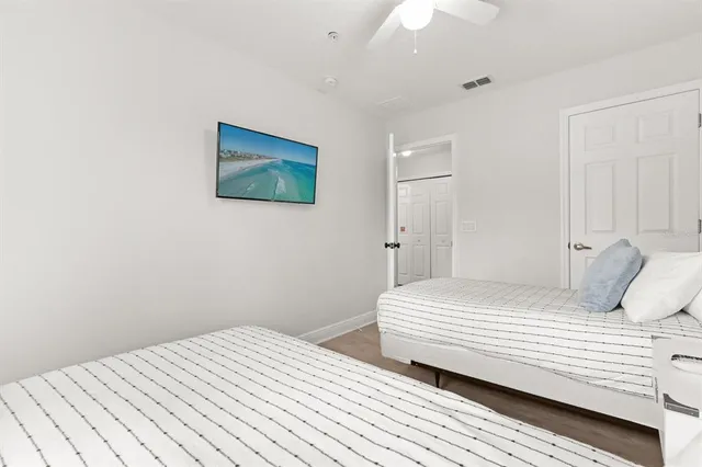 a bedroom with a large bed and a chandelier