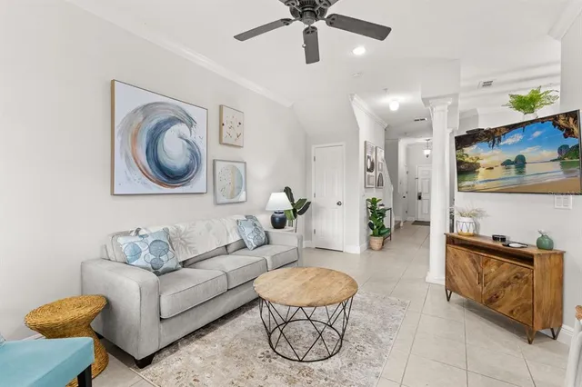 a living room with furniture and a wall painting