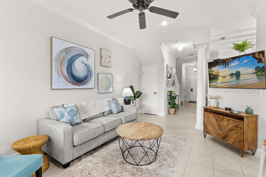 856 Assembly Court Reunion, FL 34747 - Photo 5 of 37 a living room with furniture and a wall painting