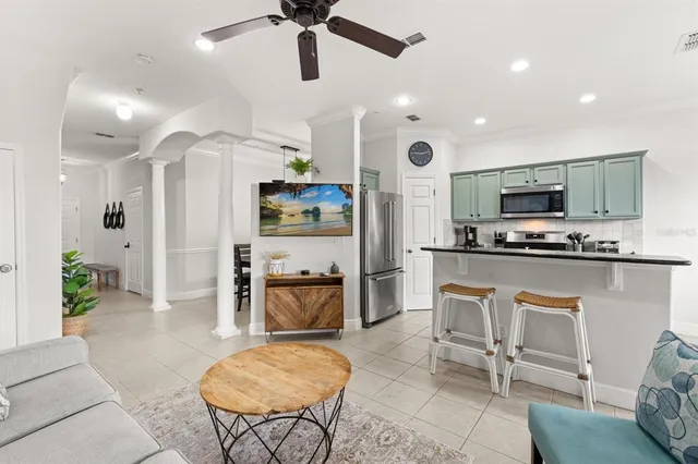 a living room with furniture and kitchen view