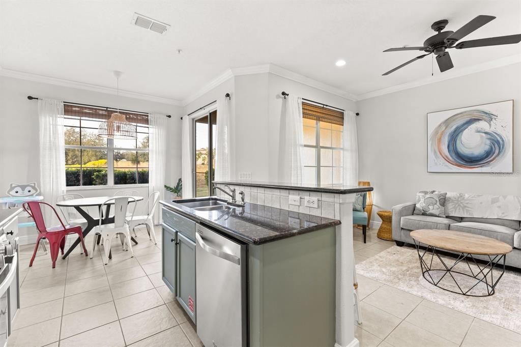 856 Assembly Court Reunion, FL 34747 - Photo 7 of 37 a kitchen with a stove a sink and a refrigerator