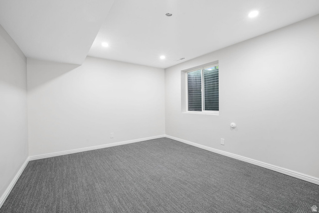 8965 Quail Run Drive Sandy, UT 84093 - Photo 25 of 56 Empty room with dark carpet and recessed lighting