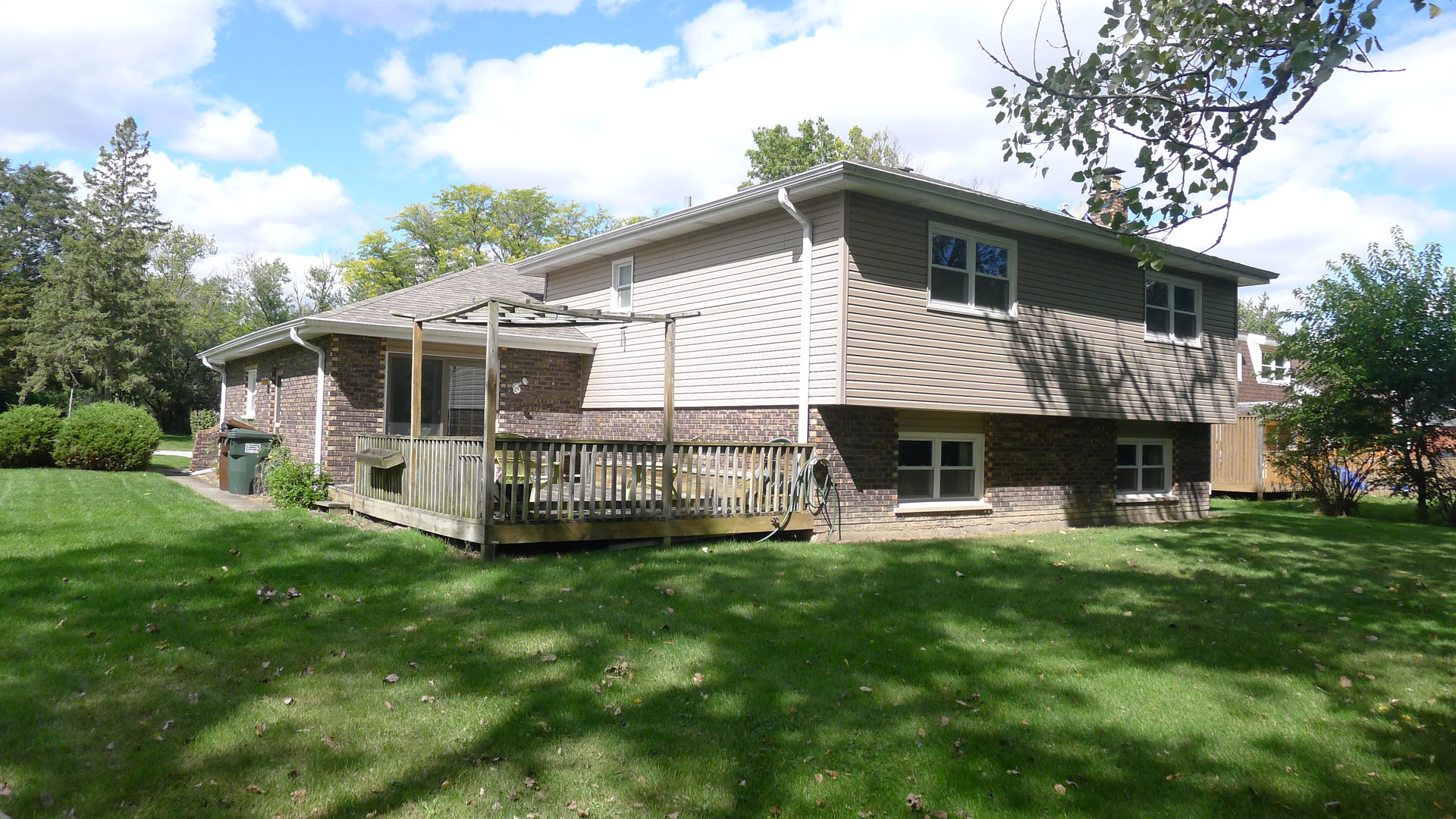 1417 Lawrence Crescent Flossmoor, IL 60422 - Photo 18 of 24 a front view of a house with a garden and deck